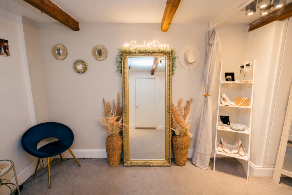 Private fitting room with a gold framed mirror at Scarlet Poppy Bridal Boutique in Pudsey